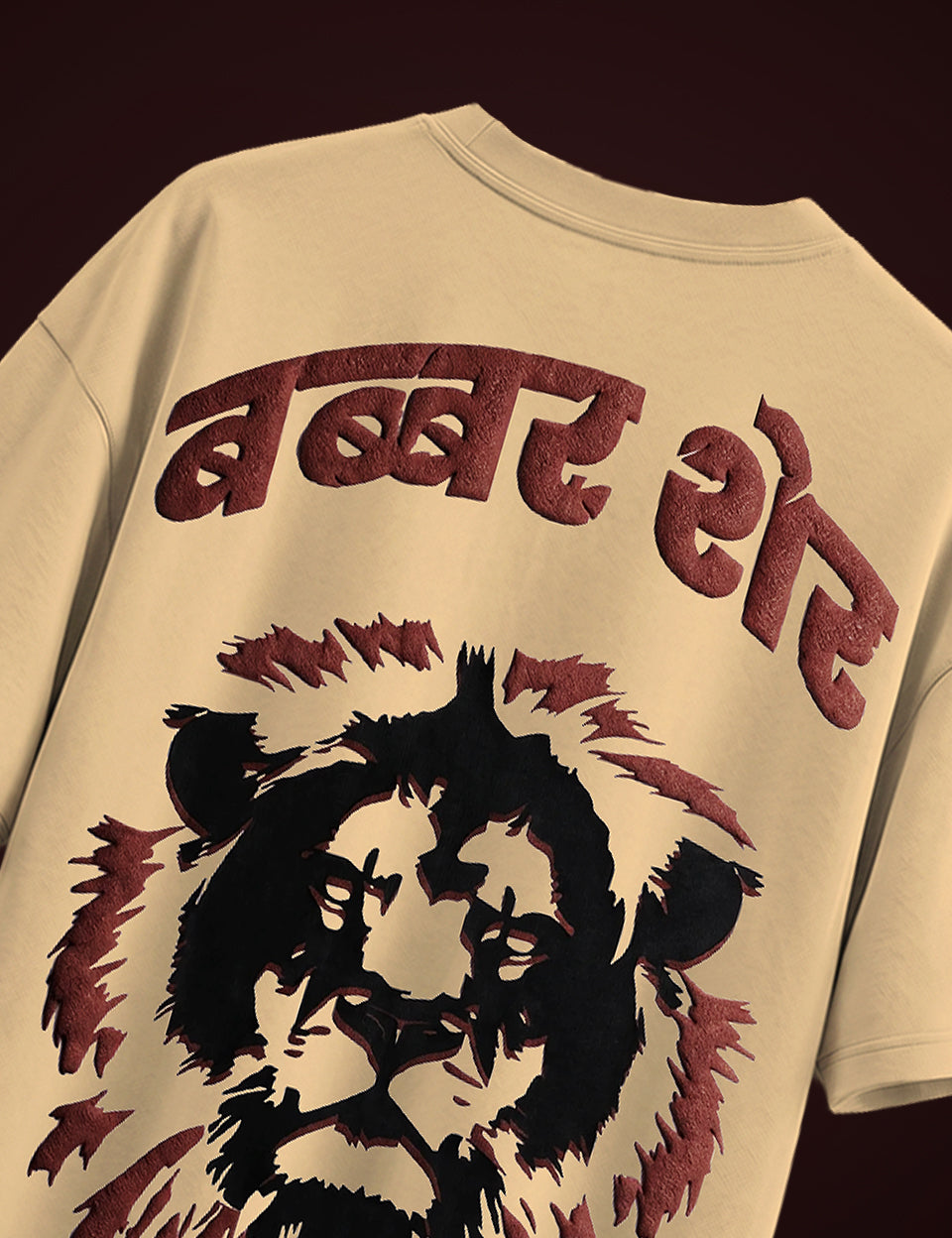 Close-up of Naram Babbar Sher oversized tshirt back showing bold maroon Devanagari puff print text and detailed lion screen print on beige cotton