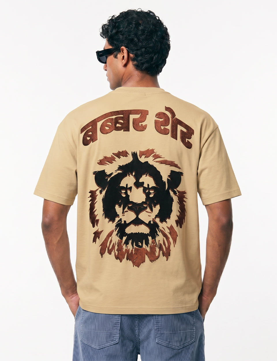 Back view of Naram Babbar Sher beige oversized tshirt on model showing full Hindi lion graphic screen print, Indian streetwear