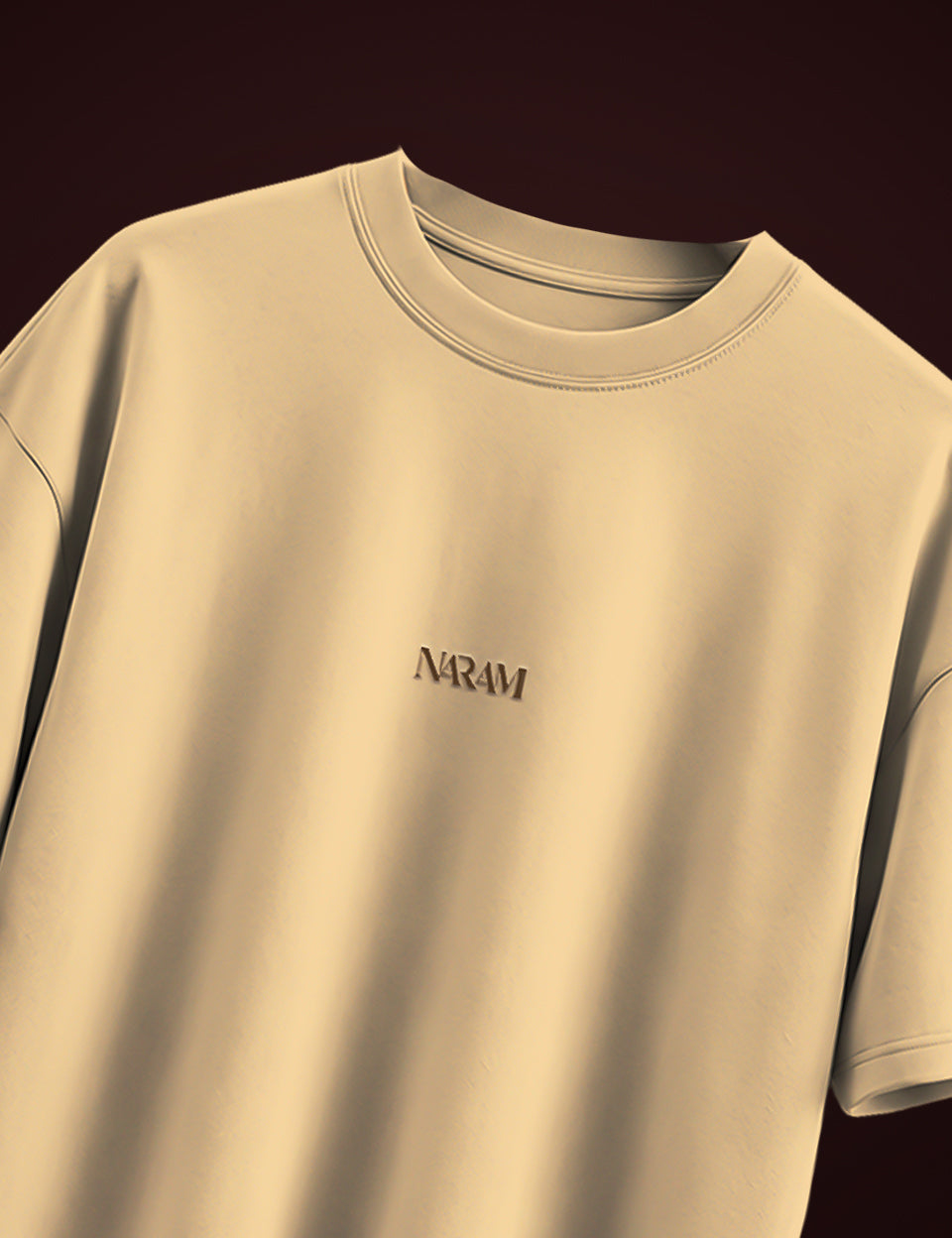 Naram Babbar Sher beige oversized tshirt front flat product shot with tonal embroidered Naram logo on chest, dark background