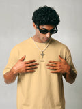 Close-up of Naram chest logo on beige oversized t-shirt  minimal Indian streetwear identity