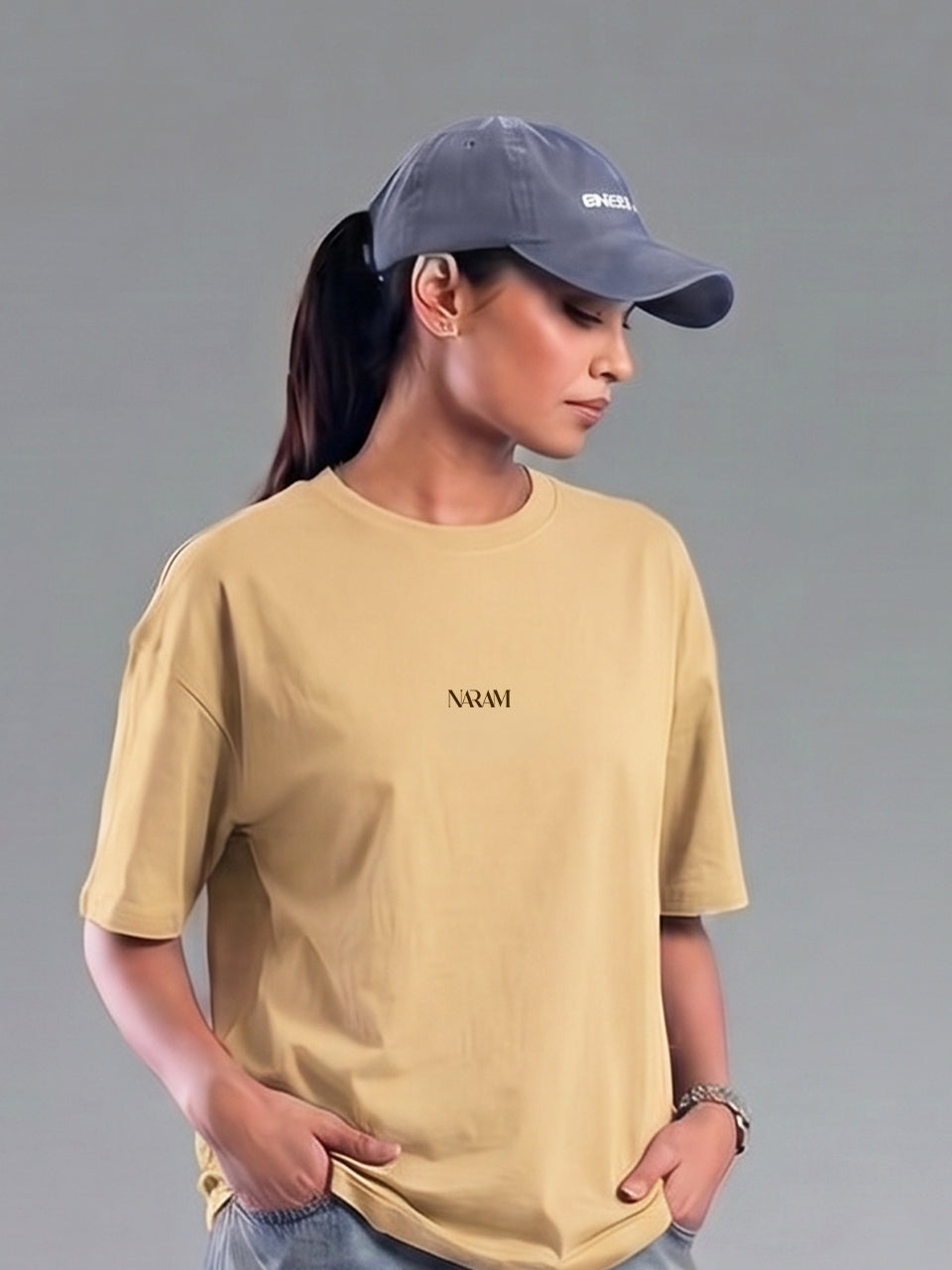 Woman wearing Naram oversized beige t-shirt with cap minimal Indian streetwear brand