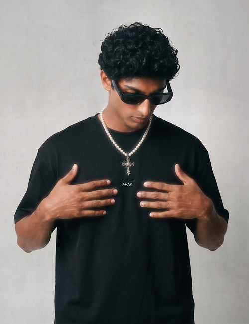 close-up-chest-logo-streetwear.jpgClose-up of Naram chest logo on black oversized t-shirt  minimal Indian streetwear brand identity