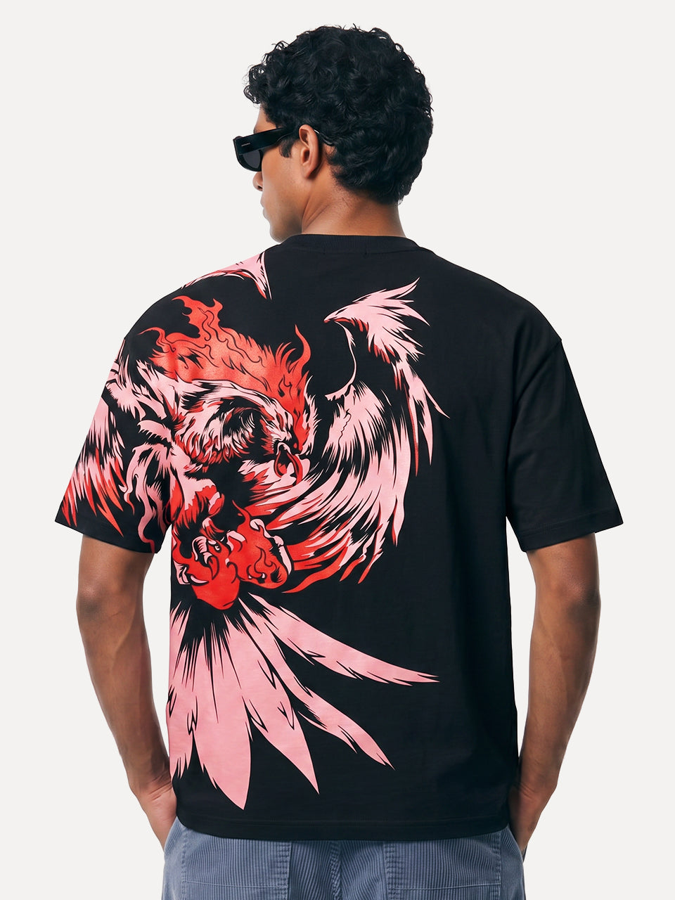 
Back view of Naram Eagle oversized tshirt showing full phoenix fire bird graphic in red and pink on black cotton tee