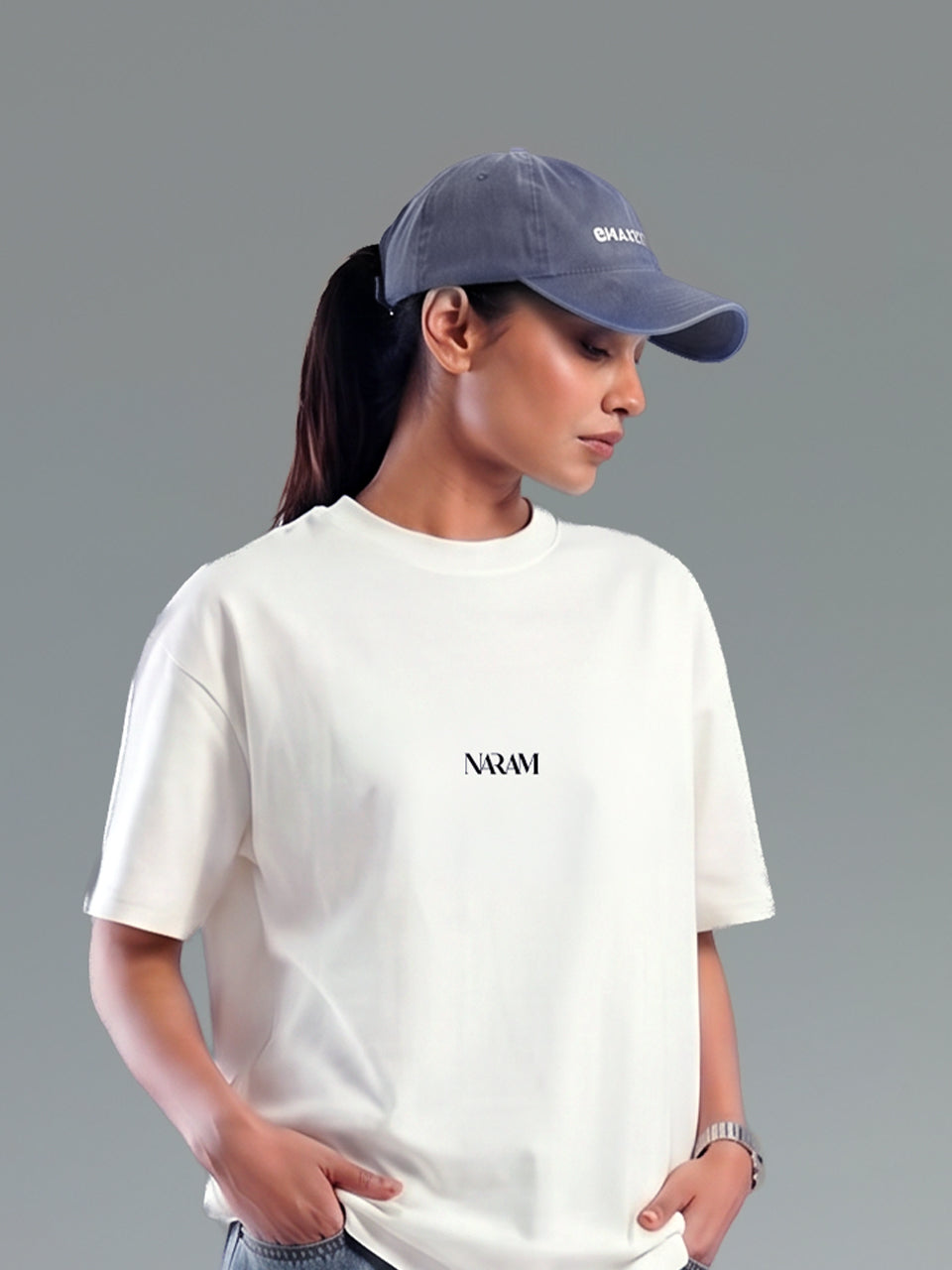 Woman wearing Naram oversized beige t-shirt with cap minimal Indian streetwear brand