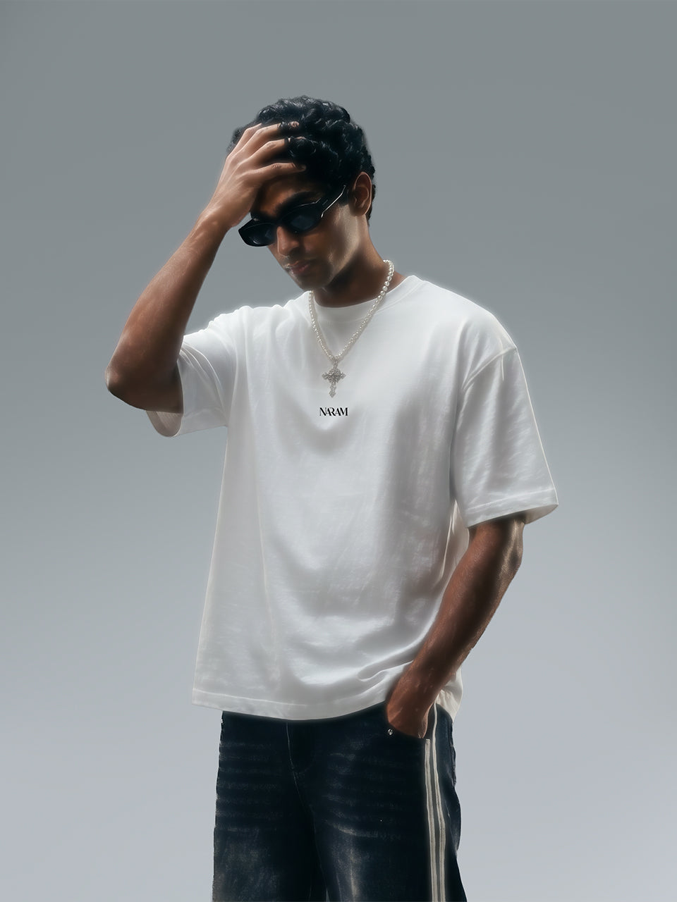 Naram oversized off white t-shirt worn by man styled with accessories Indian streetwear brand