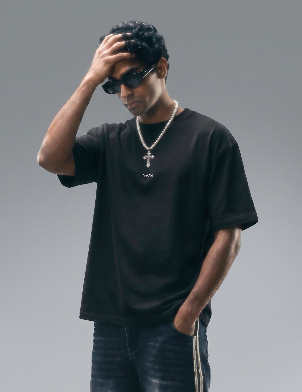 Naram oversized black t-shirt worn by man with pearl necklace and sunglasses . Indian streetwear brand