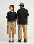 Naram oversized black t-shirt shown on two models front and back unisex fit with cargo pants
