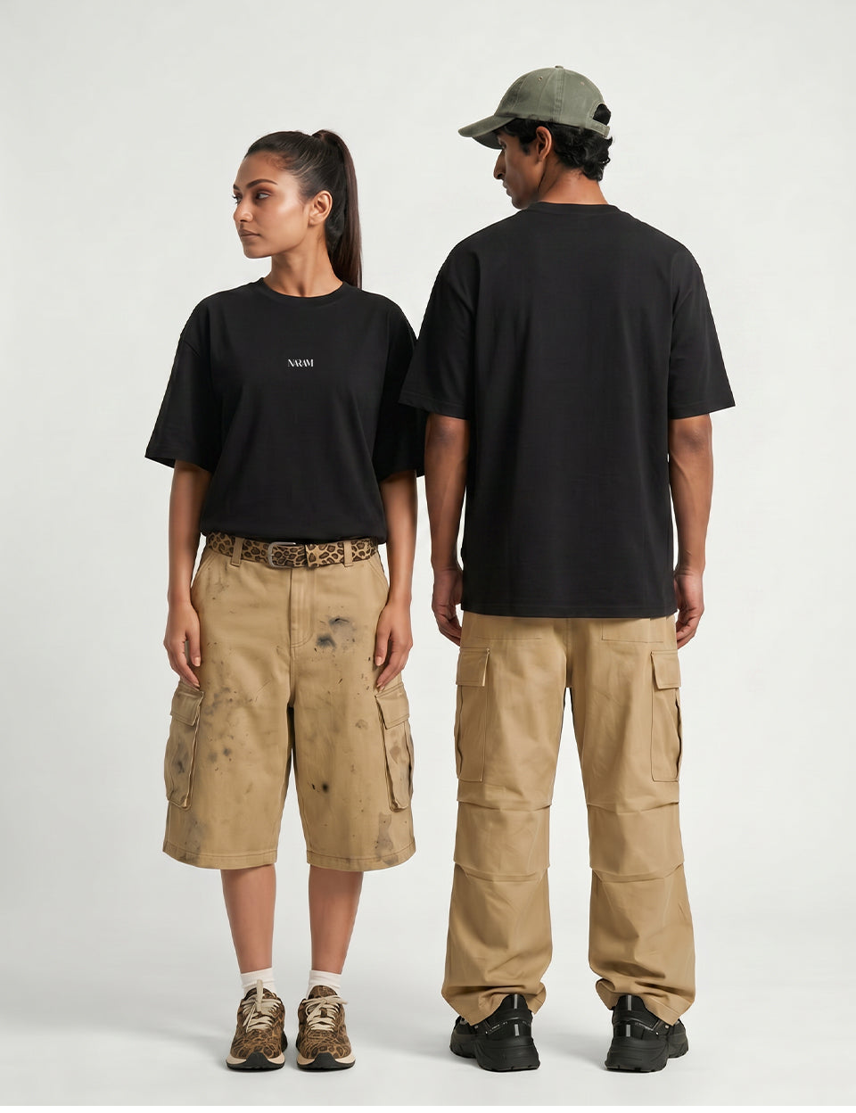 Naram oversized black t-shirt shown on two models front and back unisex fit with cargo pants